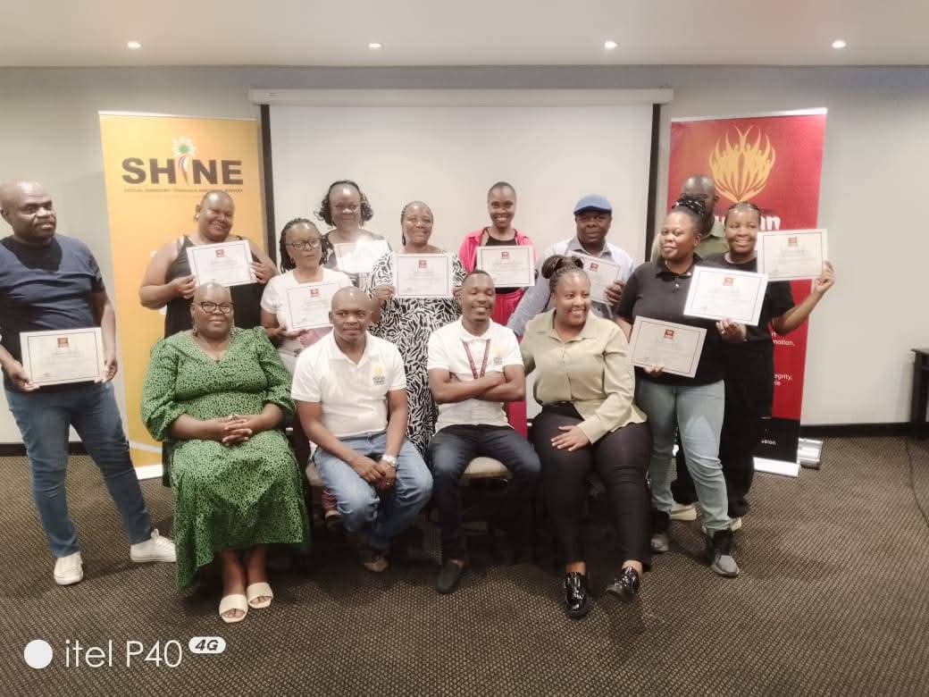 Workshop participants holding certificates at a SAHRC SHINE training session